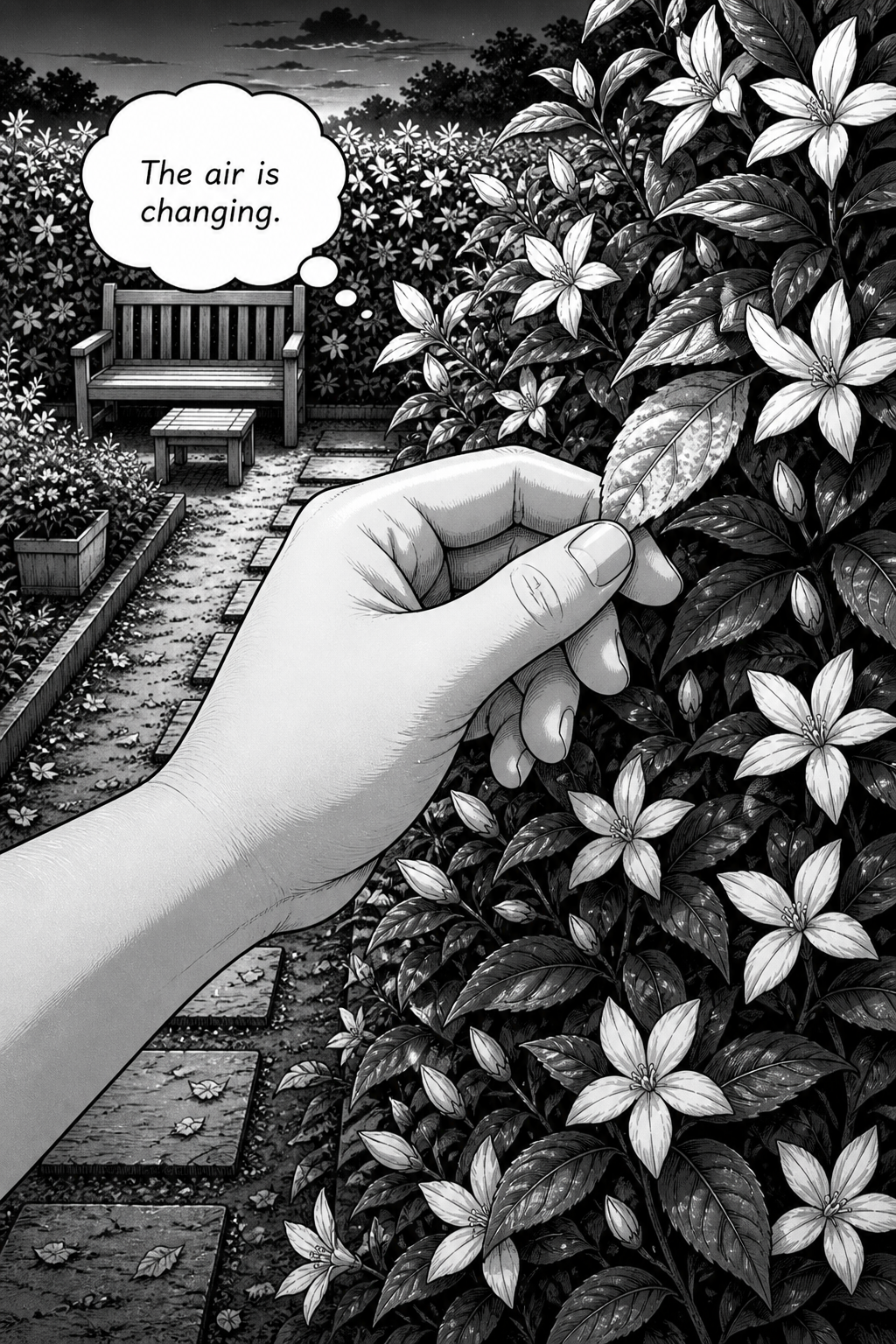 A hand gently touches a leaf on a flowering bush in a garden with a path and a wooden bench under a dark, cloudy sky.